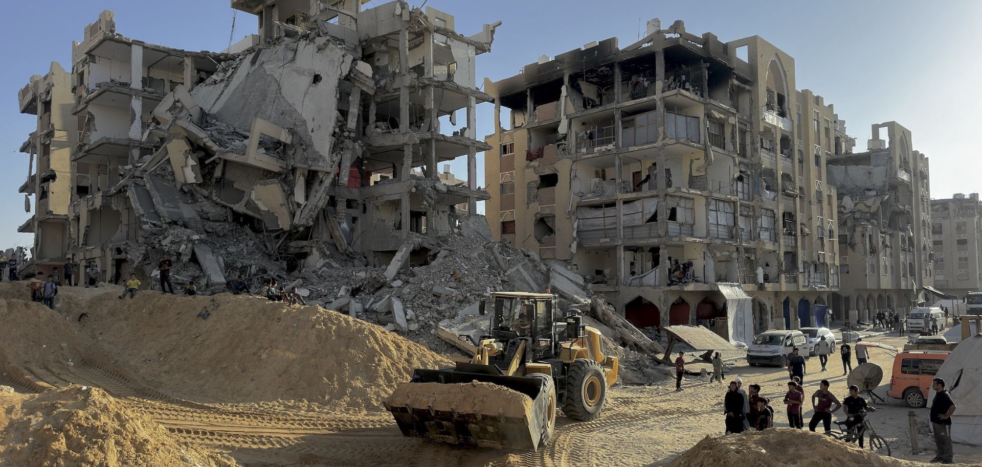 Excavation crews work amid rubble in Hamad City, west of Khan Yunis, Gaza, on Oct. 26, 2025. 