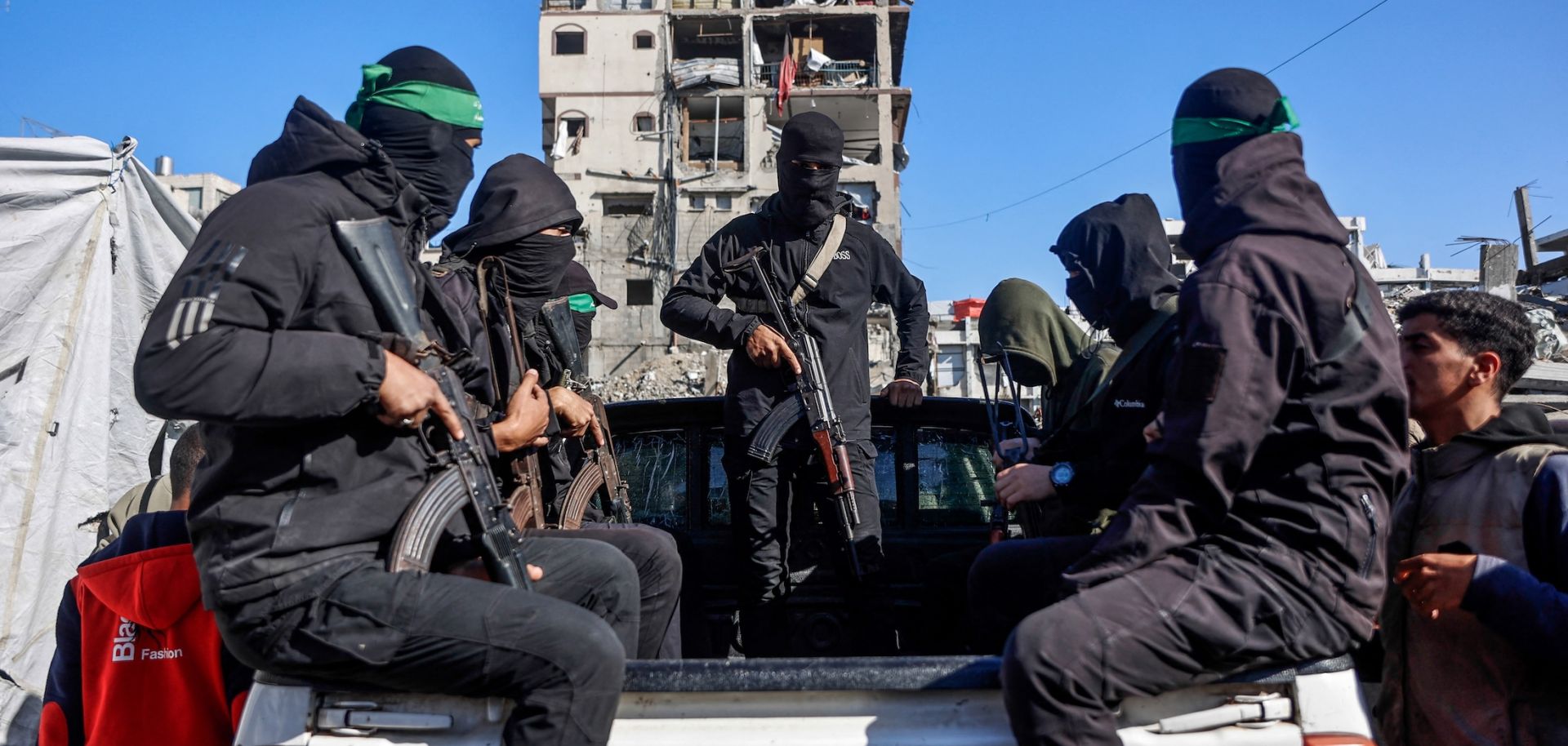 Hamas militants arrive to secure the area as Egyptian and Red Cross workers search for the bodies of the last two remaining hostages from under the rubble of the Jabalia refugee camp in northern Gaza on Dec. 1, 2025. 