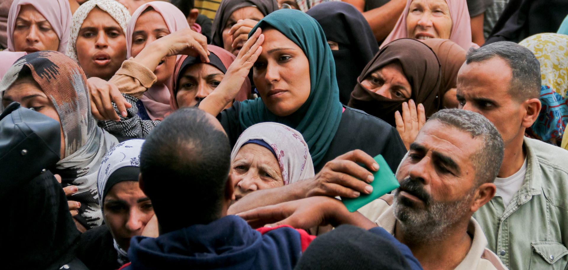 Crowds of Palestinians gather to receive food outside a U.N. aid distribution center in the Gazan city of Deir al-Balah on Nov. 2, 2024.