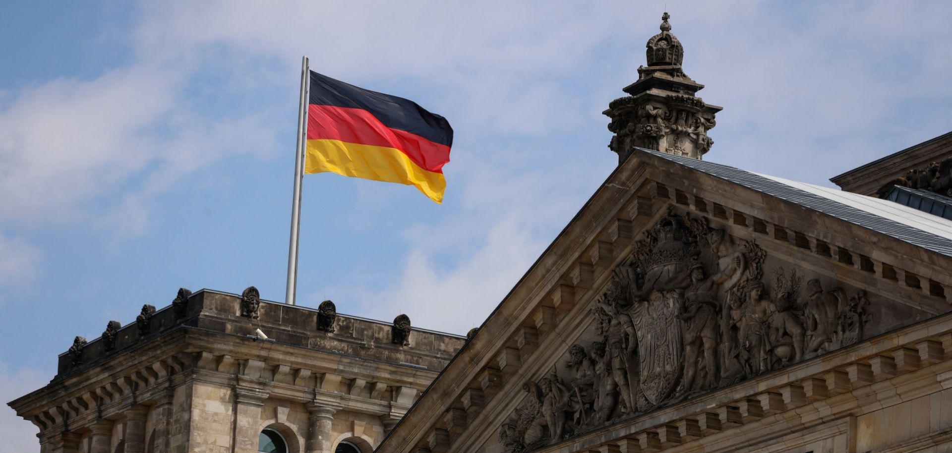 A German flag flies above the Reichstag, the building that houses the Bundestag, on July 23, 2022, in Berlin. 