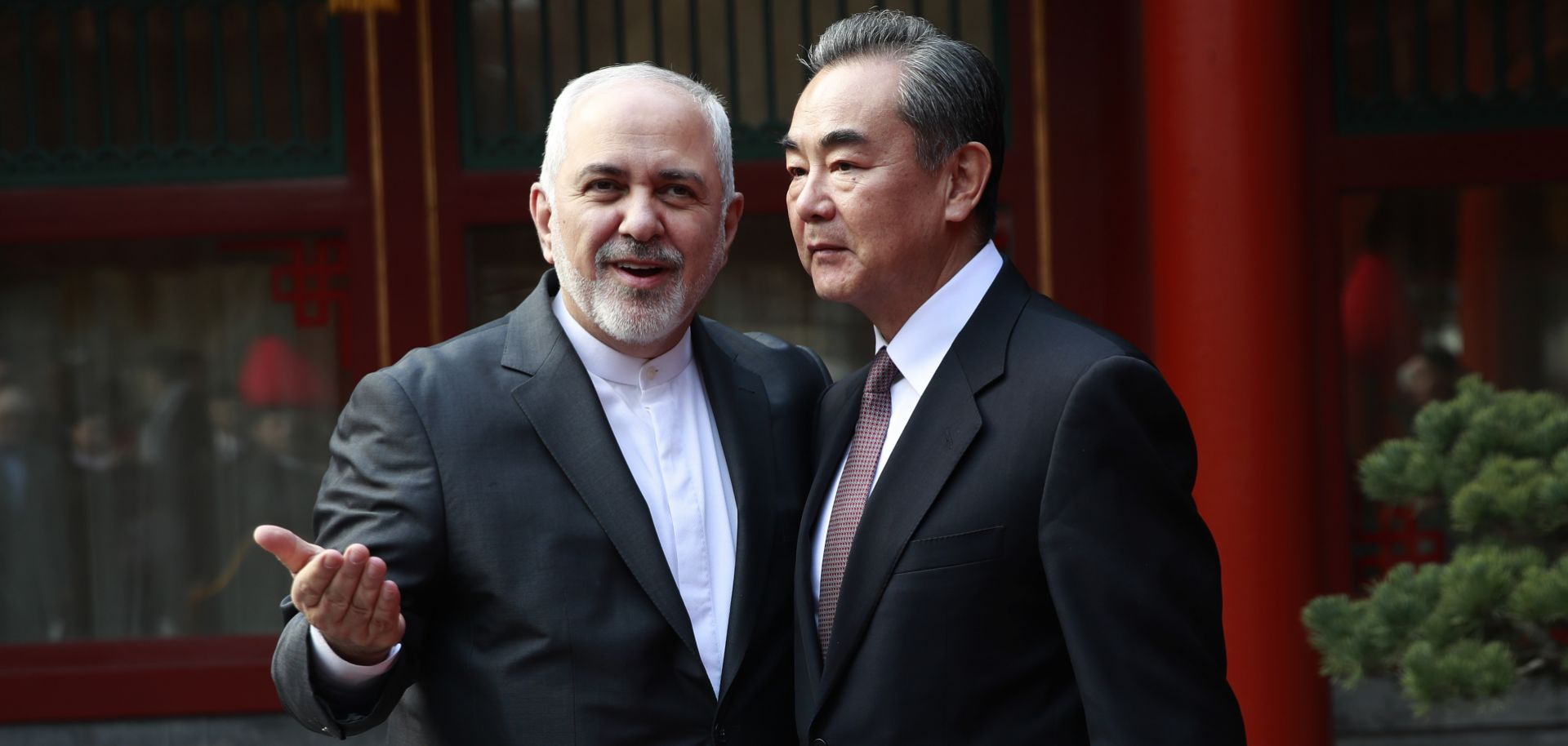 Iran's Foreign Minister Javad Zarif (L) gestures as he speaks with his Chinese counterpart, Wang Yi, during a meeting in Beijing on Feb. 19, 2019. 
