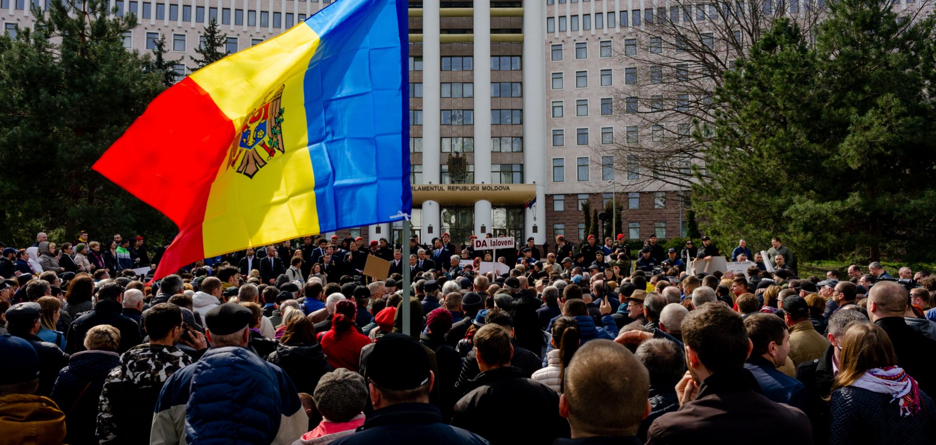 People gather outside the Moldovan parliament during a rally by the pro-European opposition ACUM bloc to protest against parliamentary election results from February.