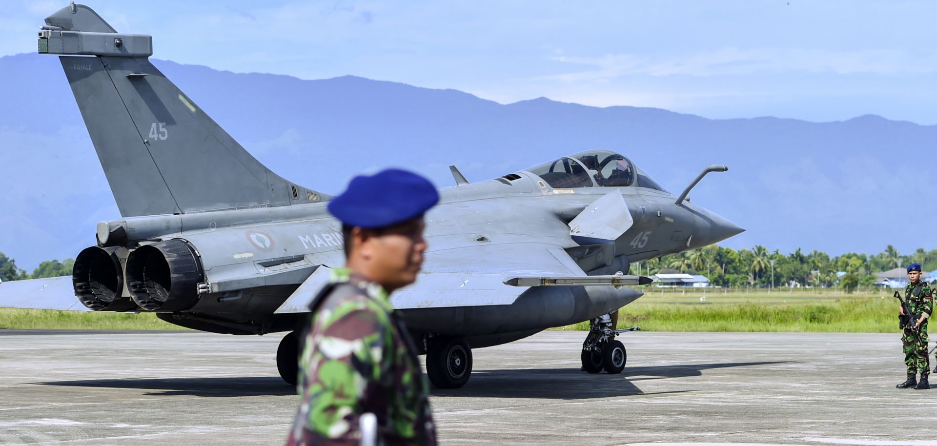 Indonesian soldiers stand guard near a French Rafale fighter jet at a military base in Blang Bintang, Indonesia, on May 19, 2019.