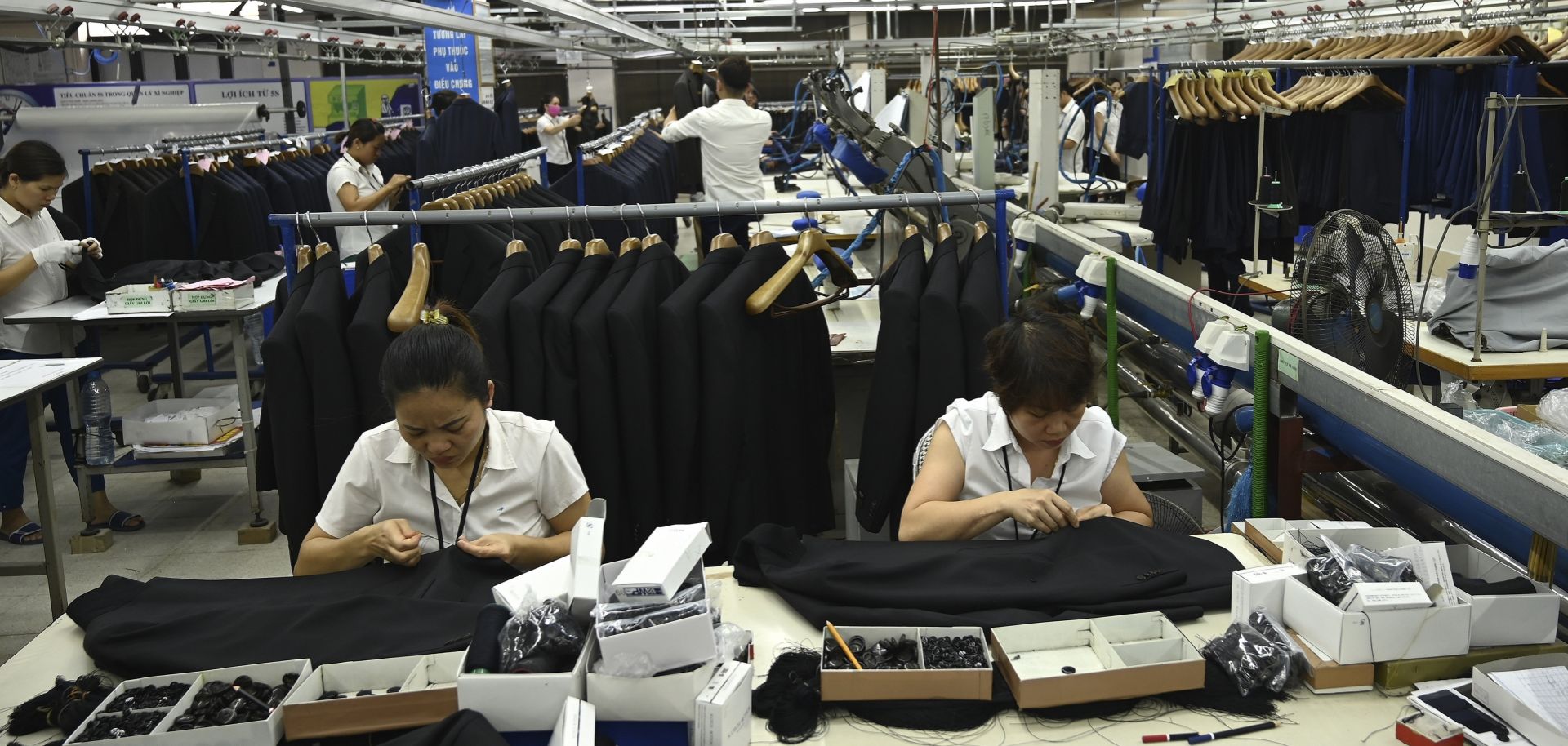 This May 24, 2019, photograph shows garment workers making men's suits in a factory in Hanoi, Vietnam.