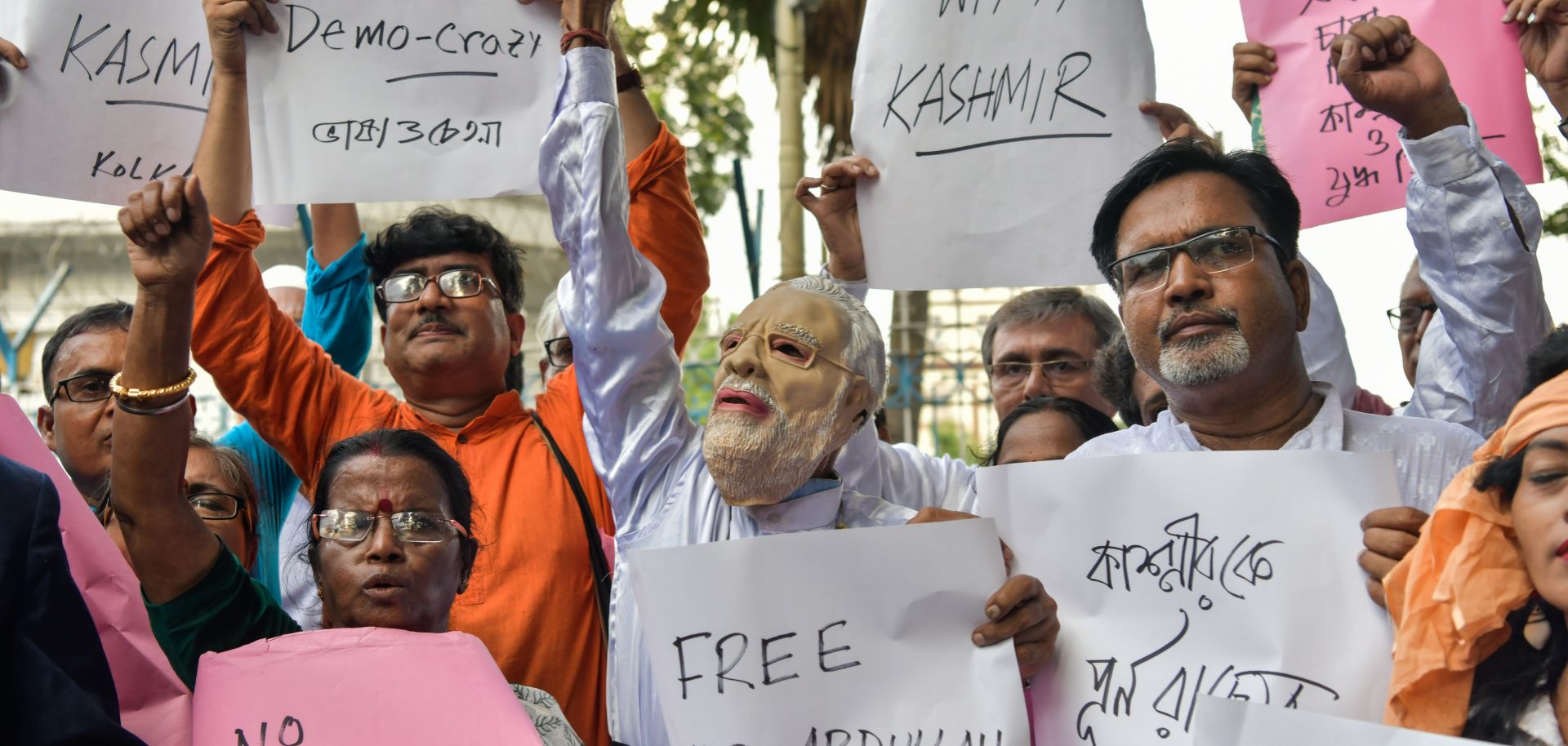 Demonstrators hold placards while shouting slogans during a protest in Kolkata on Aug. 5 at New Delhi's move to revoke Kashmir's autonomy for Jammu and Kashmir.