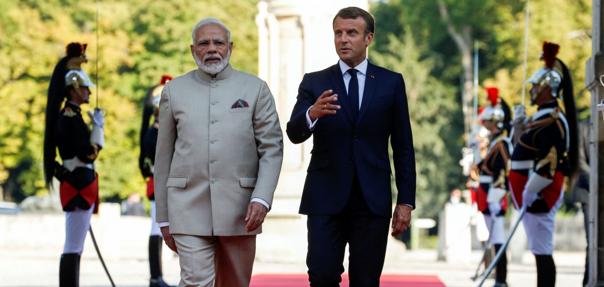 French President Emmanuel Macron (right) and Indian Prime Minister Narendra Modi walk past French Republican guards during a welcome ceremony before their meeting at the Chateau of Chantilly, near Paris, on Aug. 22, 2019.