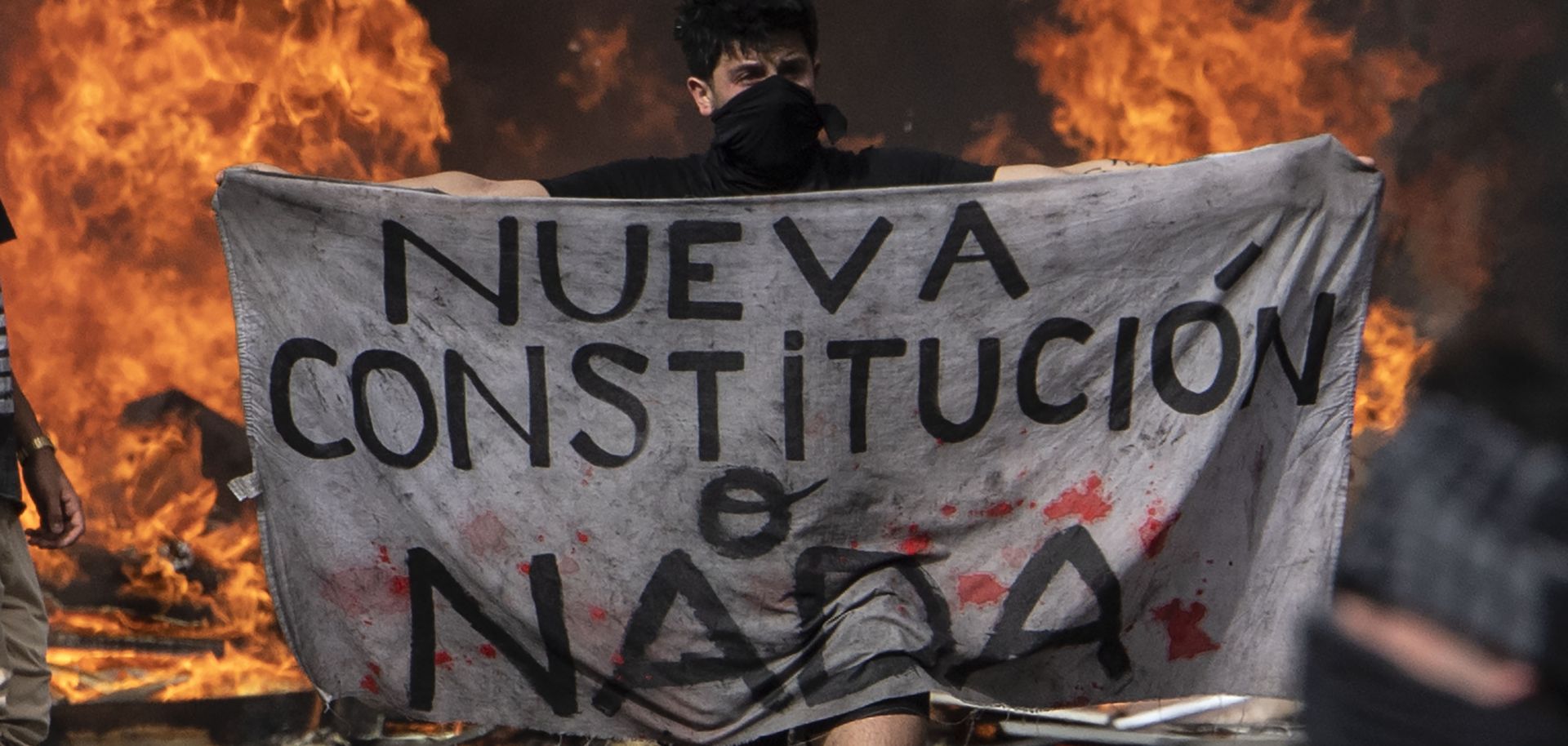 A protester holds a piece of cloth reading "New Constitution or Nothing" during a demonstration in Santiago, Chile, on Oct. 22, 2019. 