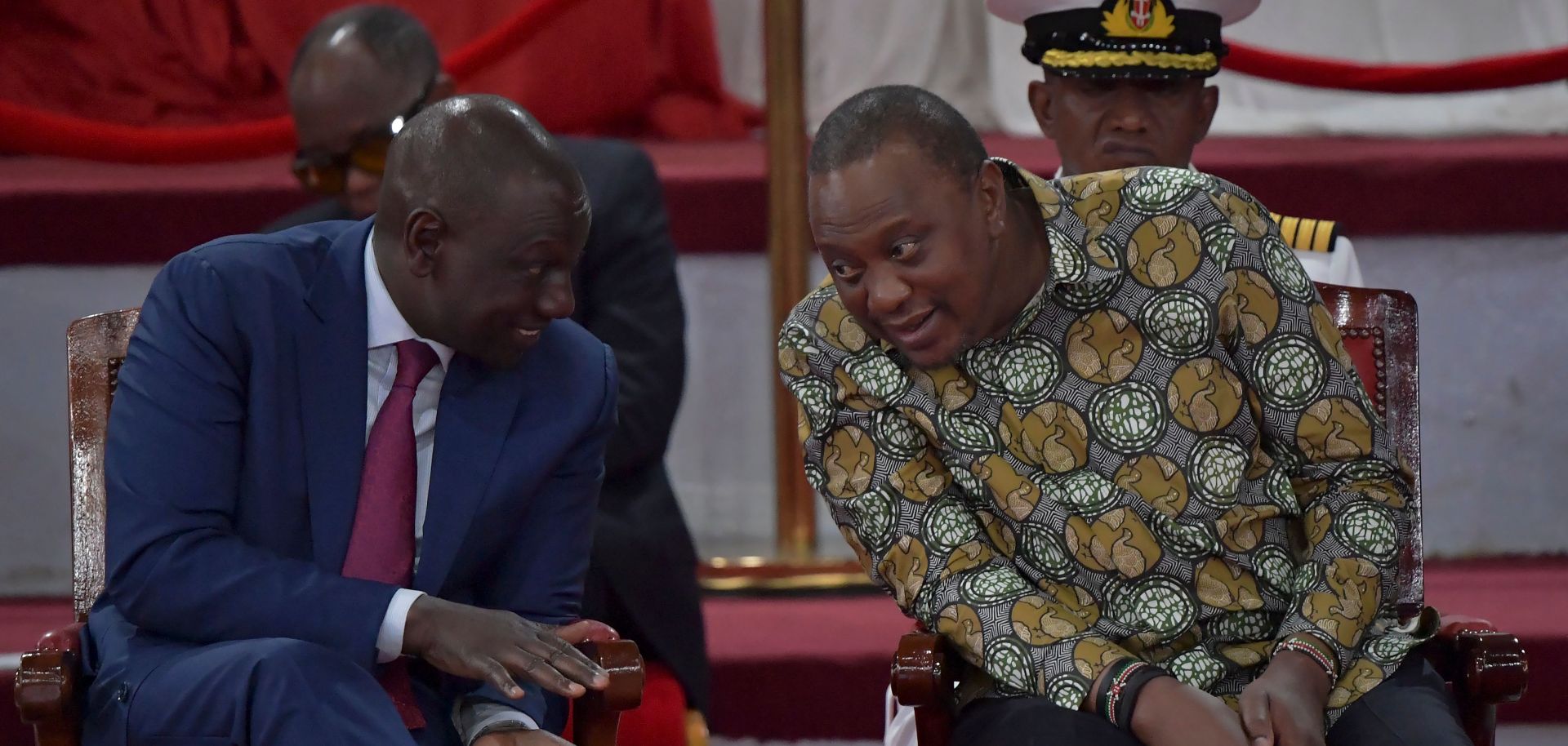 Kenyan President Uhuru Kenyatta (right) leans in to listen to Deputy President William Ruto during a launch event for the government’s Building Bridges Initiative (BBI) bill on Nov. 27, 2019.