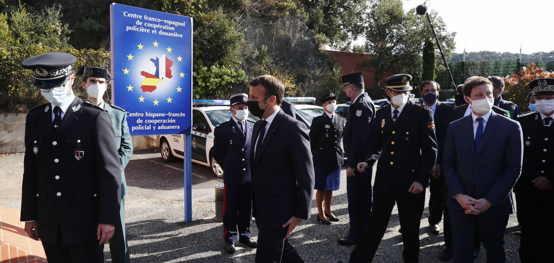 French President Emmanuel Macron (center) arrives at the Spanish border in Le Perthus, France, after he announced that the number of border guards would be doubled to 4,800 from 2,400 "because of the worsening of the threat" from terrorism on Nov. 5, 2020.