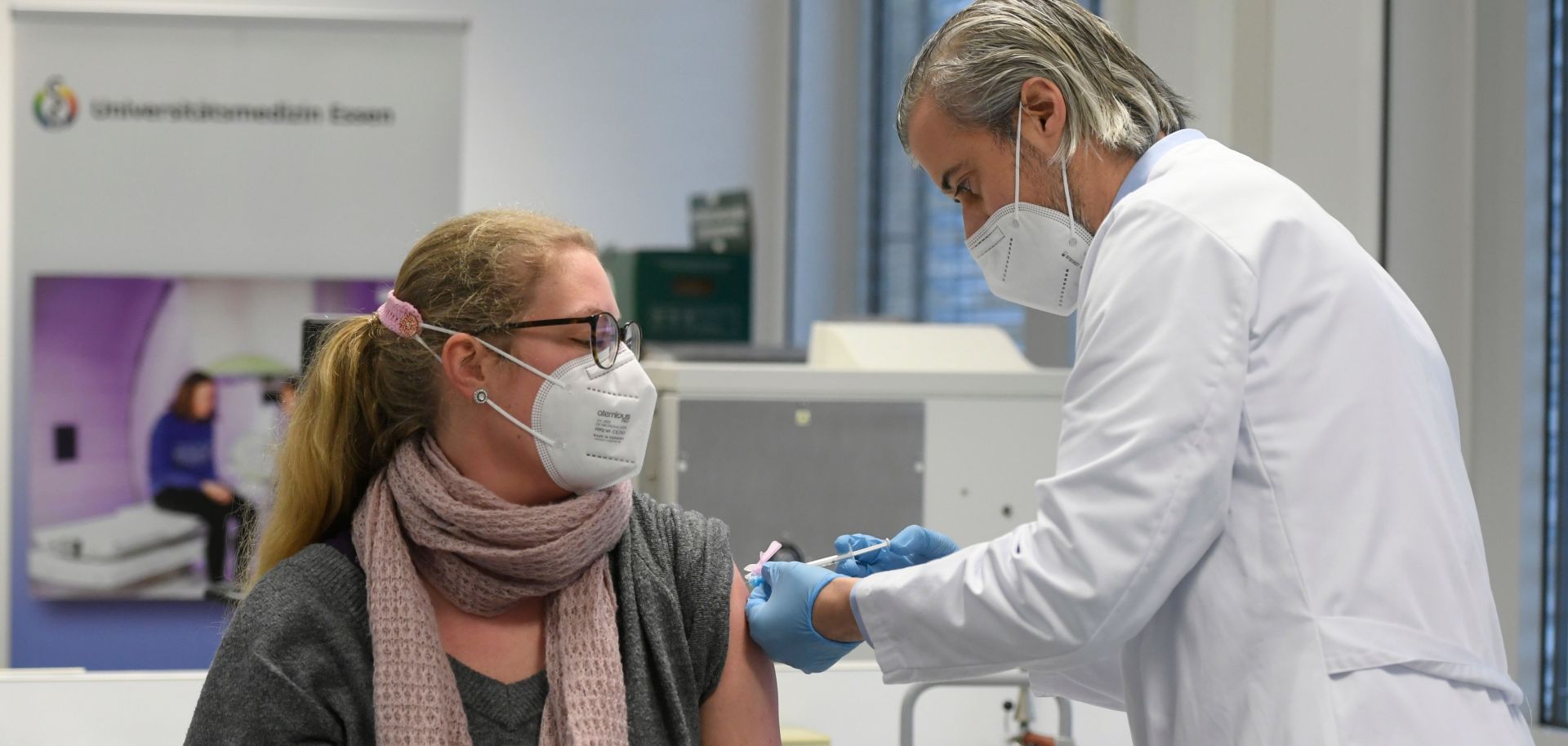 A hospital worker receives a dose of a COVID-19 vaccine in Essen, Germany, on Jan. 18, 2021. 