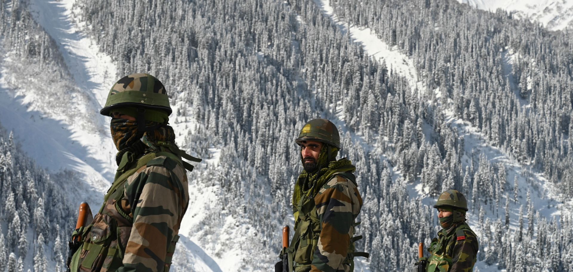 Indian soldiers walk along a road near the Zojila mountain pass that connects to Ladakh, bordering China, on Feb. 28, 2021. 