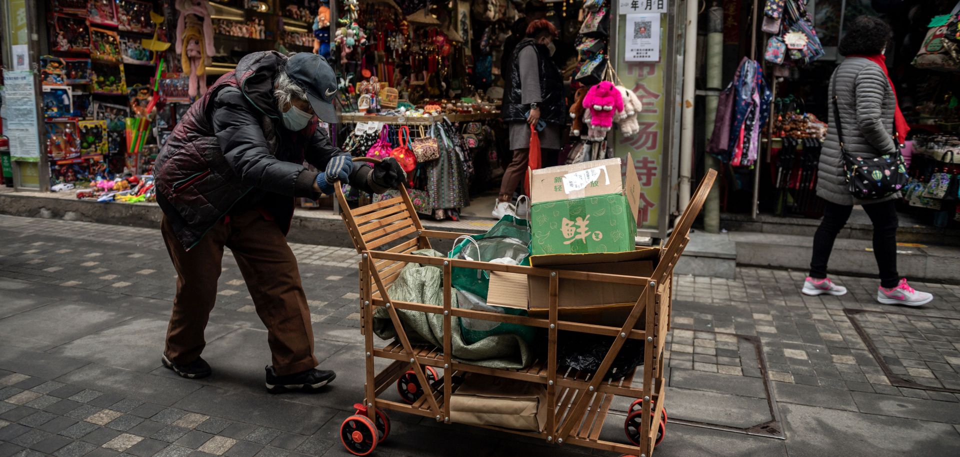 A woman pushes a cart down a street in Beijing, China, on March 5, 2021.