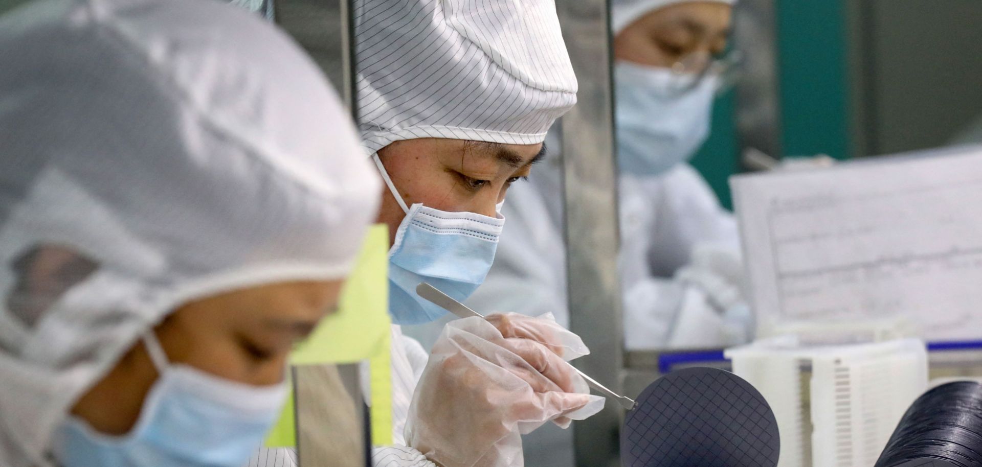Employees make chips at a semiconductor factory in China's eastern Jiangsu province on March 17, 2021. 