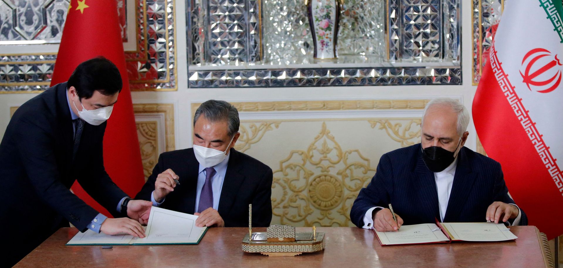 Iran and China’s foreign ministers (right to left) sign a partnership agreement in Tehran on March 27, 2021. 