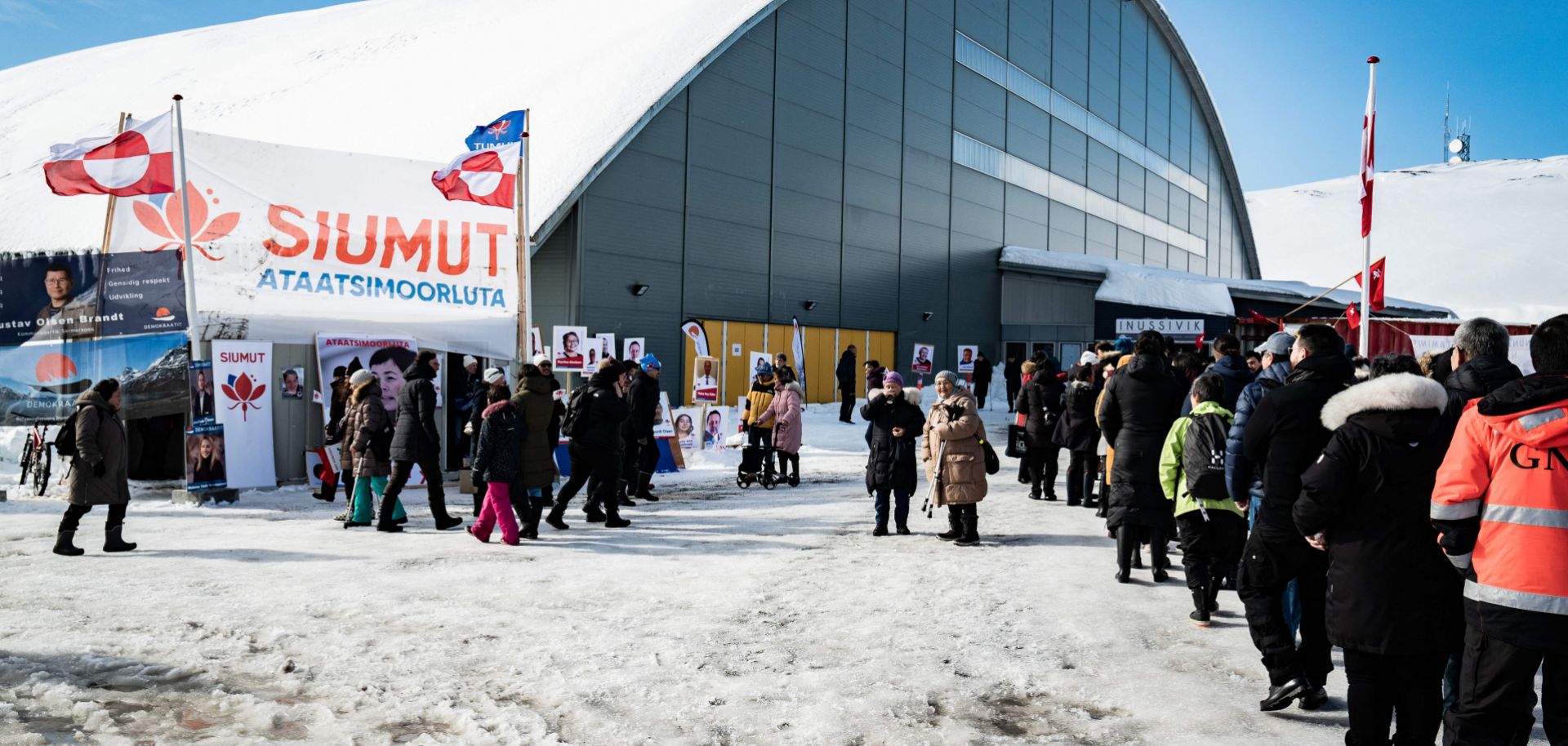 Voters stand in line to cast their ballots in the parliamentary election in Greenland's capital of Nuuk on April 6, 2021. 