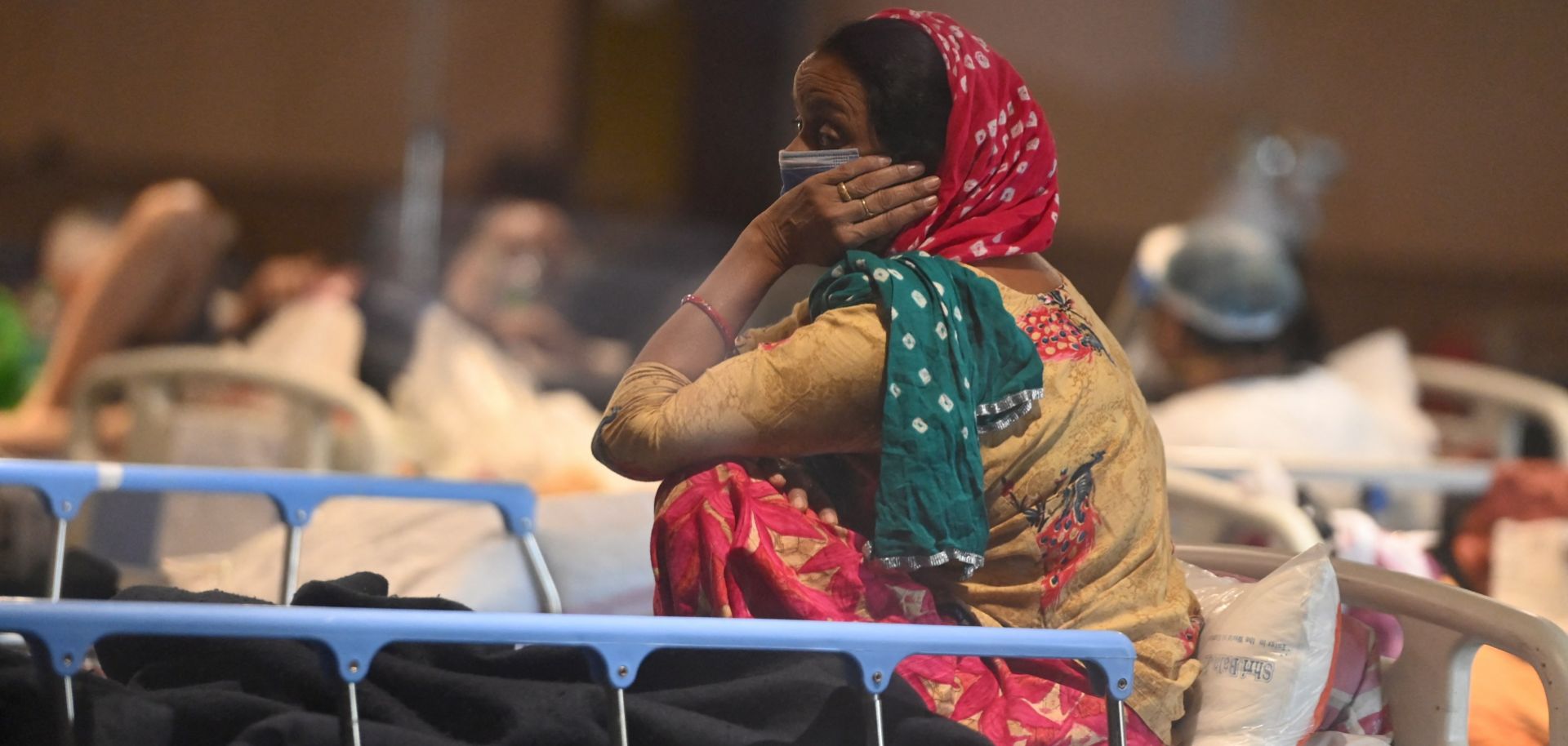 A patient rests at a banquet hall that’s been converted into a COVID-19 ward in New Delhi, India, on April 27, 2021. 