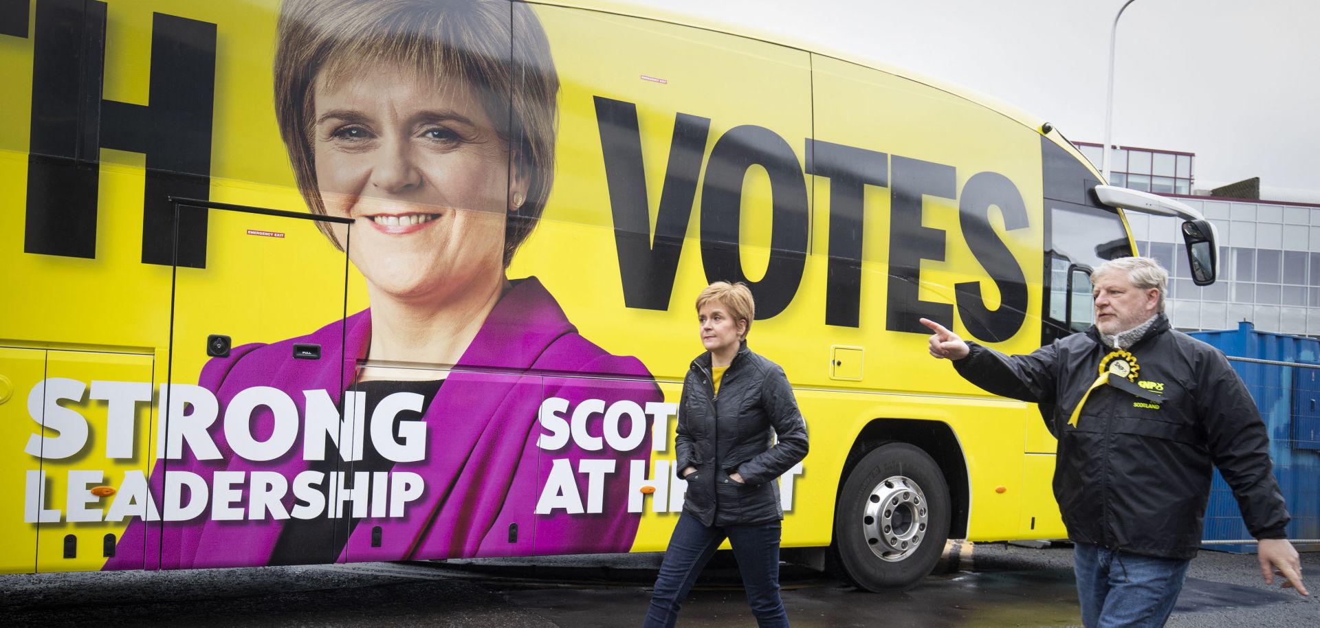 Scottish National Party (SNP) leader Nicola Sturgeon walks past her campaign bus with SNP candidate Angus Robertson in Edinburgh on May 4, 2021. 