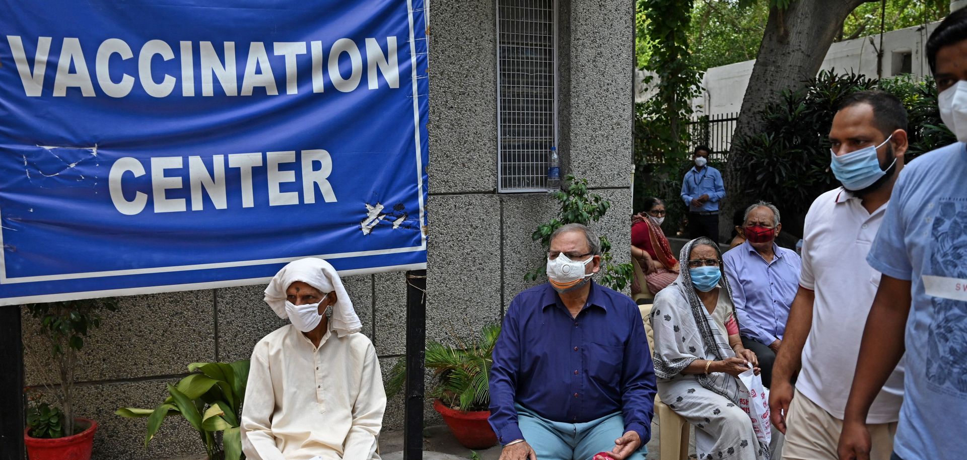 People wait to receive COVID-19 vaccines at a health center in New Delhi on May 13, 2021.
