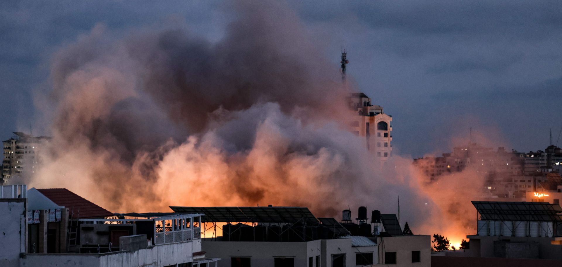 Smoke billows above buildings following an Israeli airstrike on Gaza City on May 20, 2021.