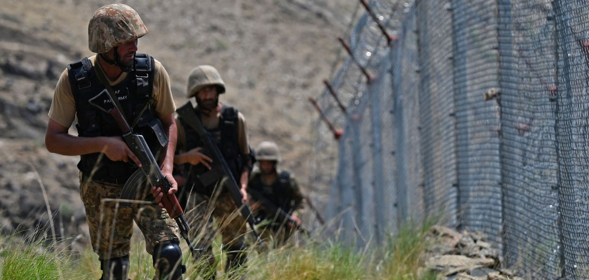 Pakistani troops patrol the fence along the Afghan border in August 2021. 