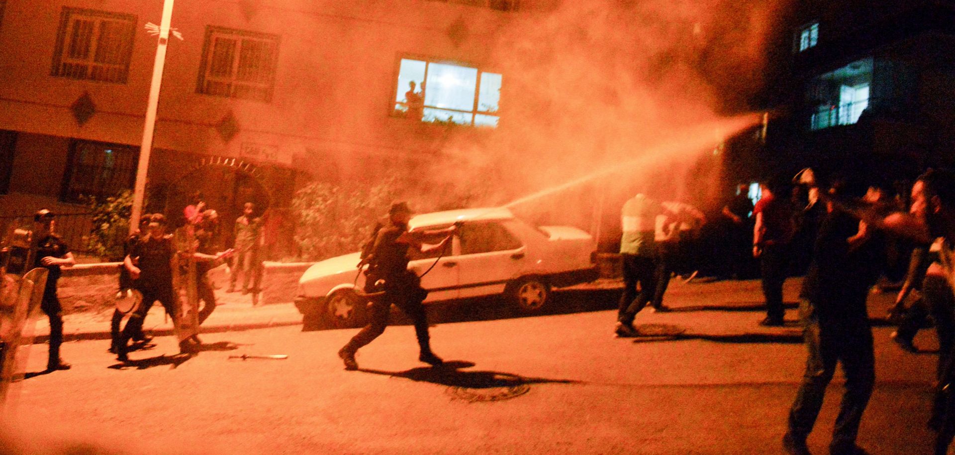 Police use tear gas to disperse clashes between locals and migrants in Ankara, Turkey, on Aug. 12, 2021. 