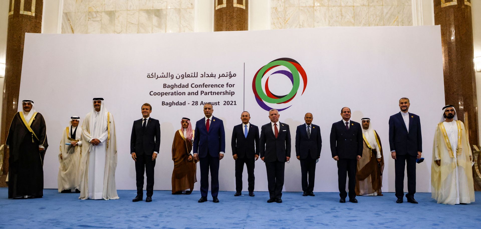 Officials from Kuwait, Qatar, France, Saudi Arabia, Iraq, Turkey, Jordan, Egypt, Iran and the United Arab Emirates, along with representatives from the Organization of Islamic Cooperation (OIC), Arab League and Gulf Cooperation Council (GCC) pose for a group photo after the meeting in Baghdad on Aug. 28, 2021. 