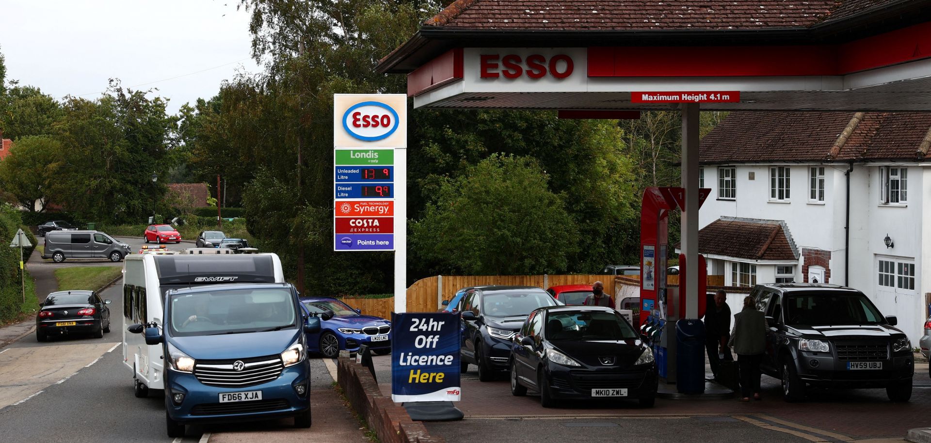 Cars line up at a gas station in the U.K. village of Odiham amid fuel shortages on Sept. 30, 2021. 