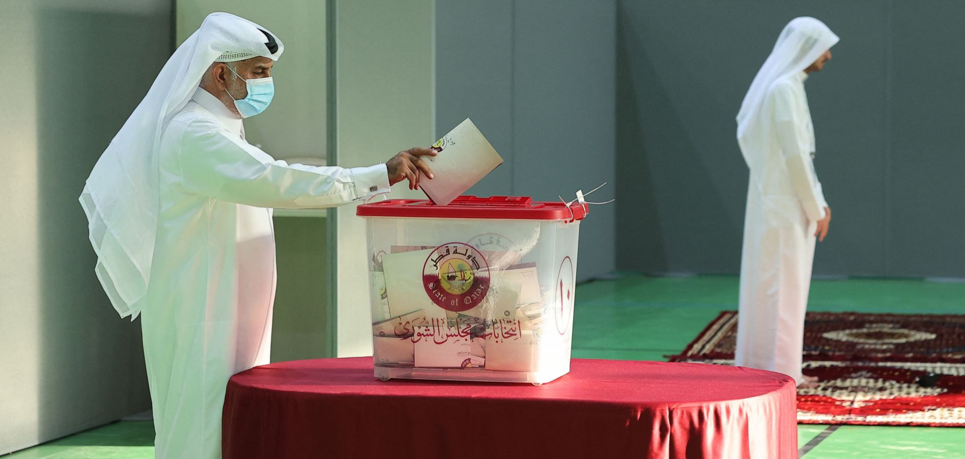 A man casts his ballot in Qatar’s first-ever legislative vote at a polling station in Doha on Oct. 2, 2021. 