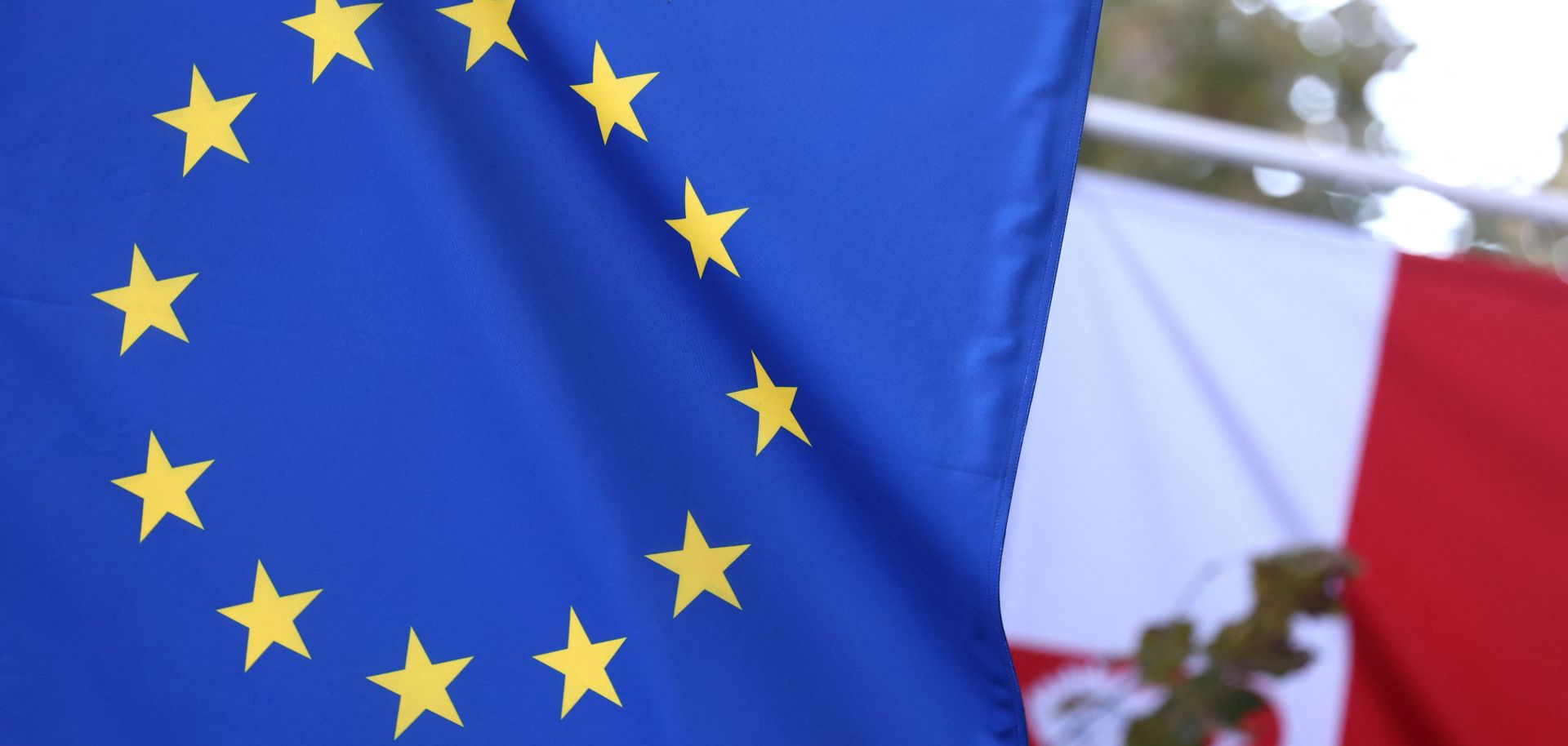 The EU and Polish flags are seen at the entrance of the Polish Permanent Representation to the European Union on Oct. 8, 2021, in Brussels, Belgium. 
