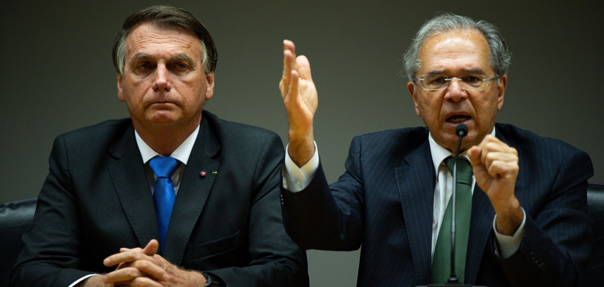 Brazilian Economy Minister Paulo Guedes (right) speaks next to President Jair Bolsonaro during a press conference on Oct. 22, 2021, in Brasilia. 
