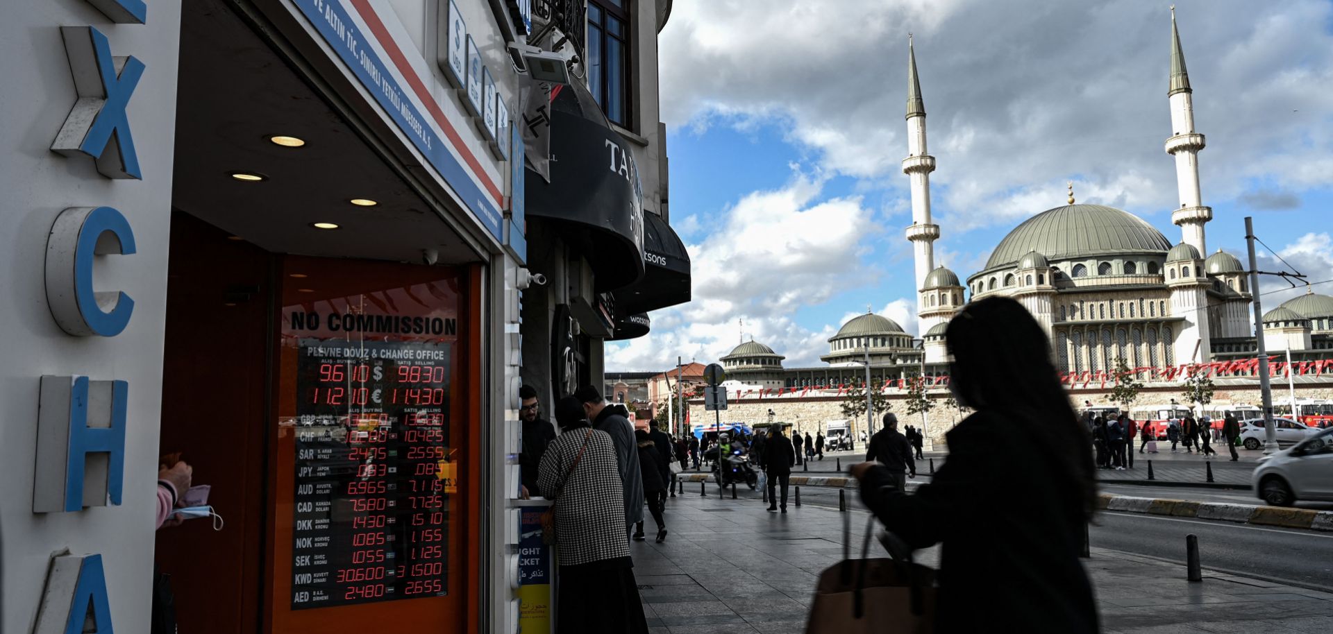 People wait outside a currency exchange agency in Istanbul, Turkey, on Oct. 25, 2021. 