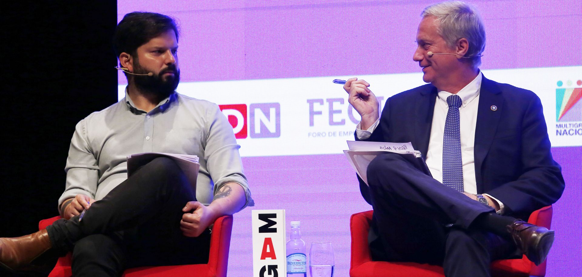 Chilean presidential candidates Gabriel Boric (left) and Jose Kast talk during a debate in Santiago, Chile, on Nov. 2, 2021. 