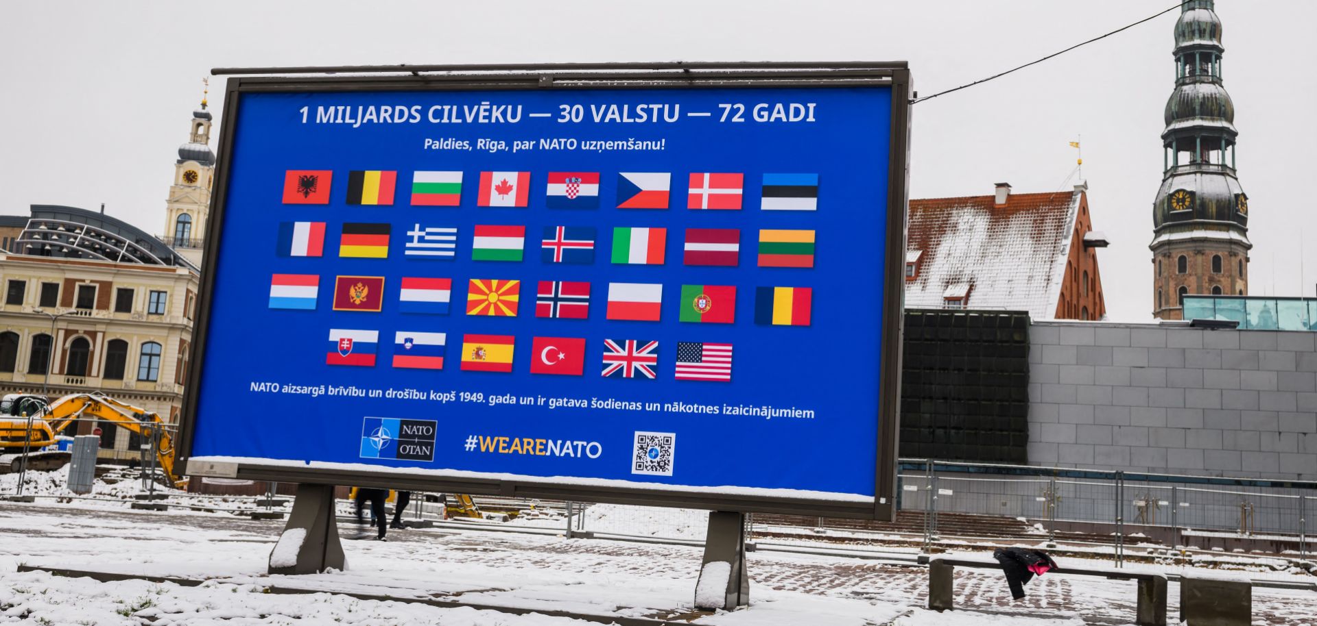 The flags of NATO member countries are seen on a billboard in Riga, Latvia, on Nov. 28, 2021, two days before the start of meetings to discuss Russia’s military buildup near Ukraine. 