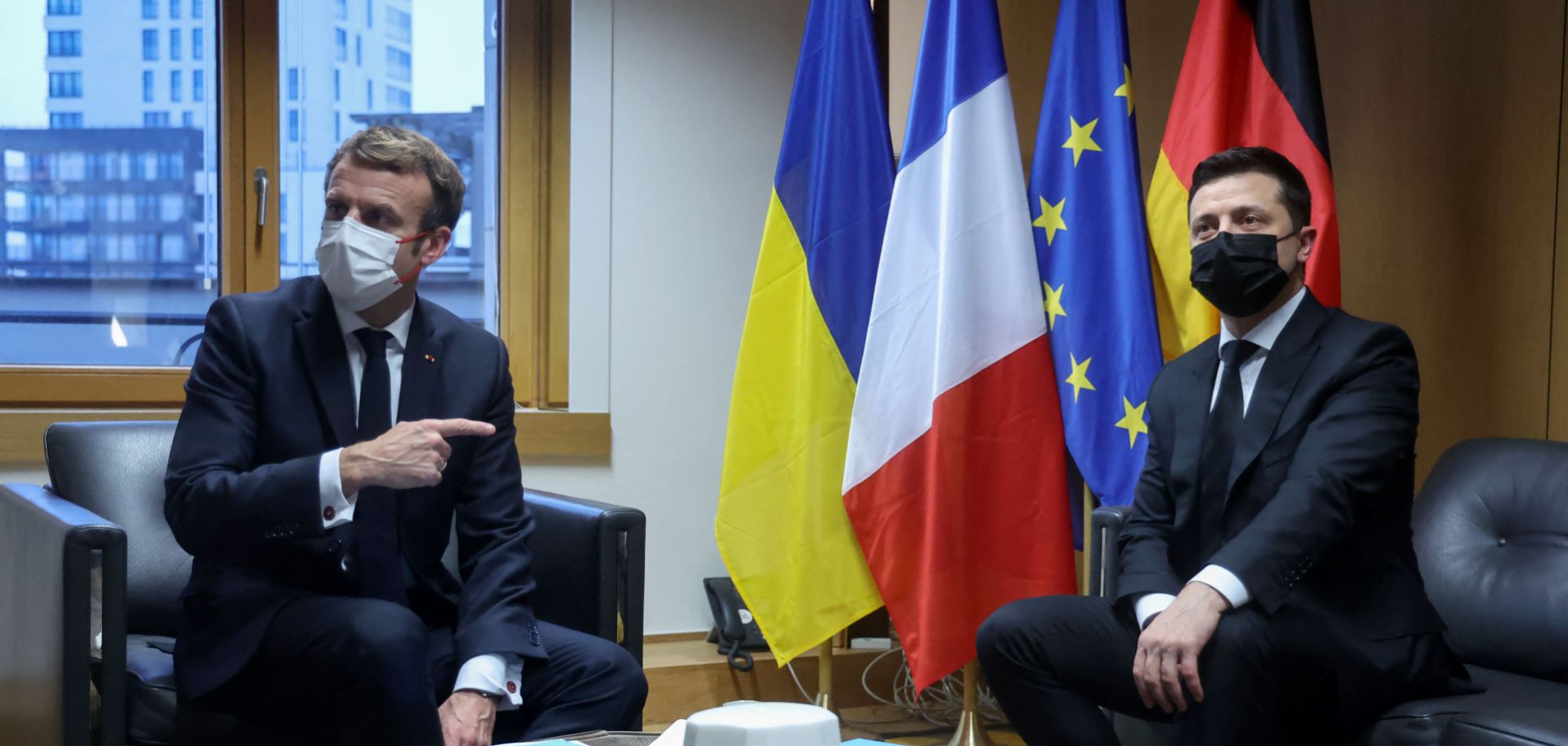 French President Emmanuel Macron (left) meets with Ukrainian President Volodymyr Zelensky during an Eastern Partnership summit at the European Council headquarters in Brussels, Belgium, on Dec. 15, 2021. 