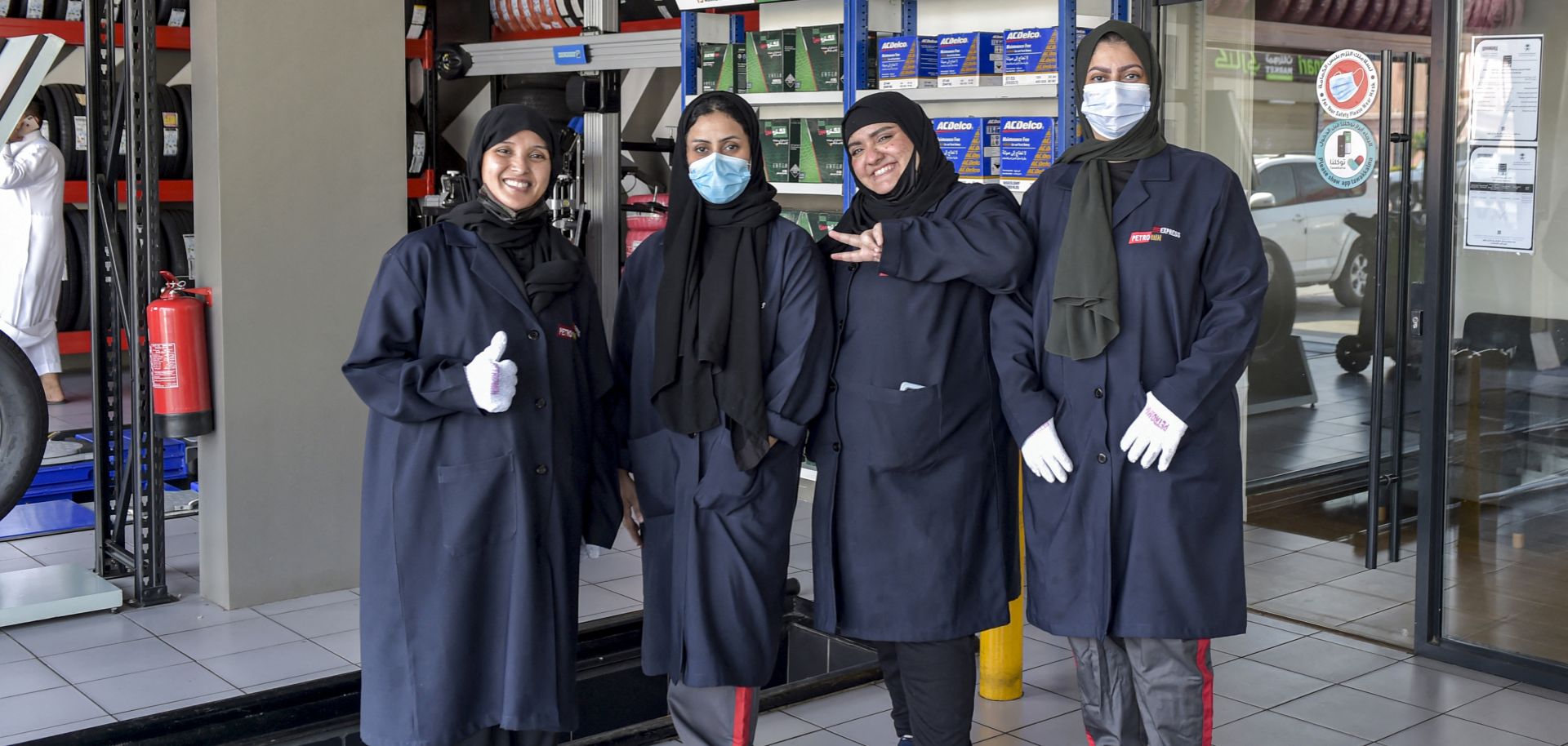 Women mechanics pose for a photo at a car repair and service shop in Jeddah, Saudi Arabia, on Dec. 27, 2021.