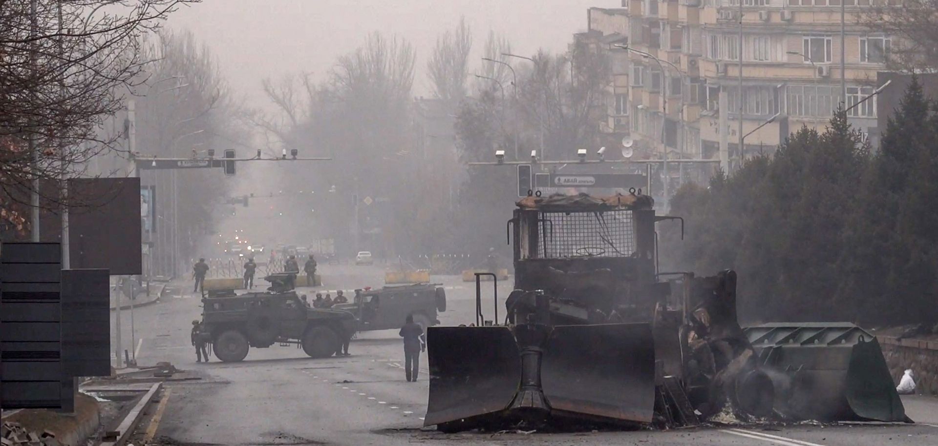 Servicemen and their military vehicles block a street in Almaty, Kazakhstan, on Jan. 7, 2022, following violent protests in the city. 
