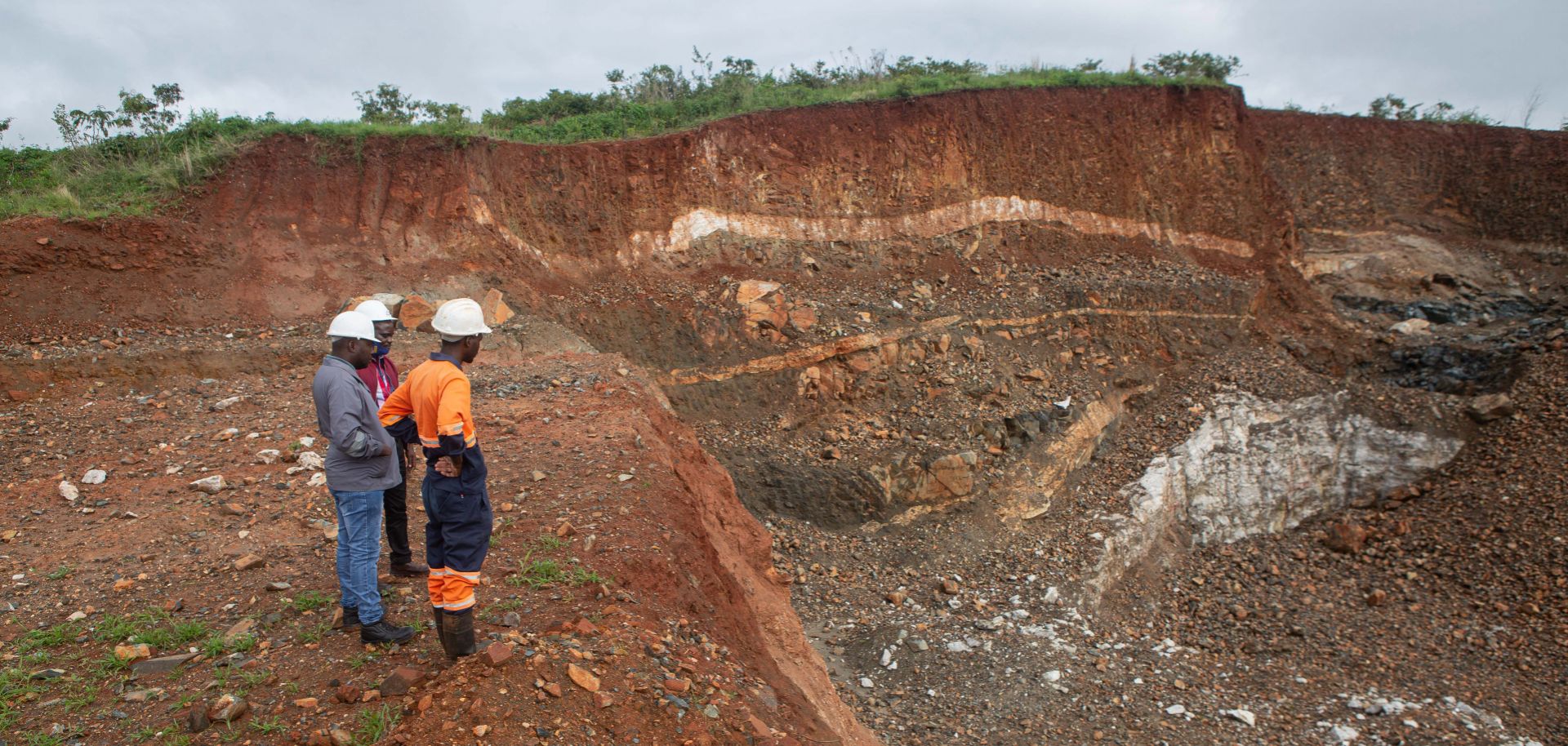 Workers inspect an open cast at the Arcadia lithium mine in Goromonzi, Zimbabwe, on Jan. 11, 2022. 