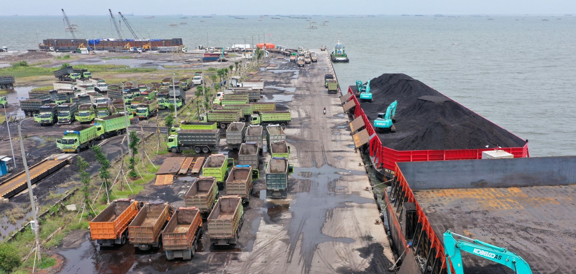 Machinery is used to load coal onto trucks at a port in Jakarta, Indonesia, on Jan. 17, 2022. 