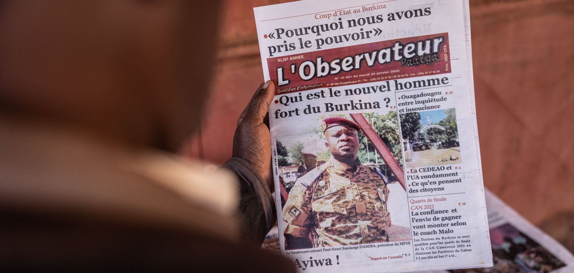 A photo of Lt. Col. Paul Henri Sandaogo Damiba, leader of Burkina Faso’s recent military coup, is seen on the front page of a newspaper in Ouagadougou on Jan. 25, 2022. 