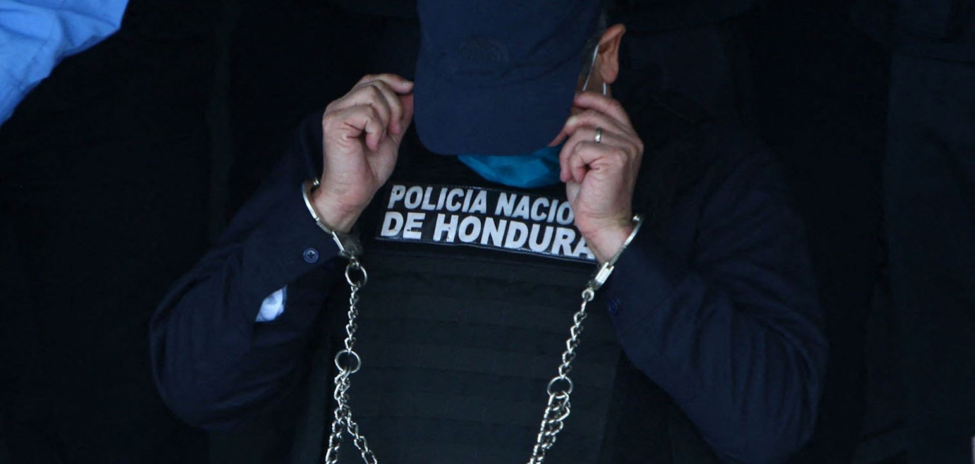 Juan Orlando Hernandez, the former president of Honduras, is seen handcuffed at the headquarters of the country’s police force in Tegucigalpa on Feb. 15, 2022. He was arrested after receiving an extradition order from the United States. 