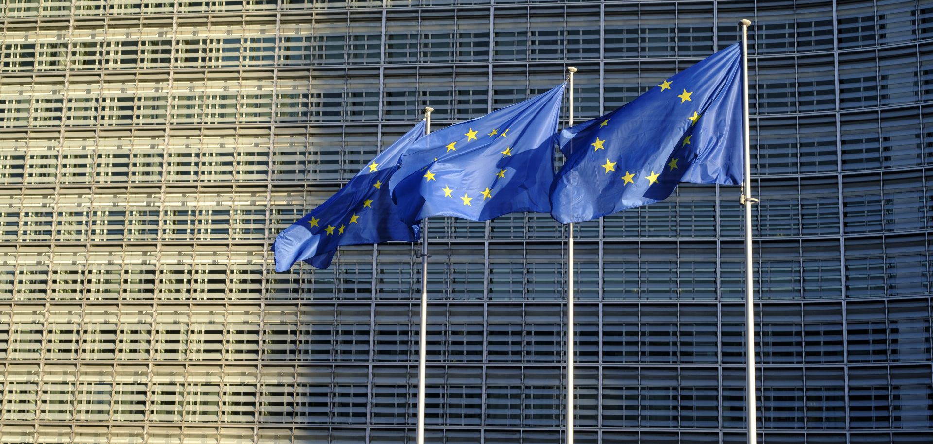 EU flags fly outside the headquarters of the European Commission on Feb. 23, 2022, in Brussels, Belgium. 