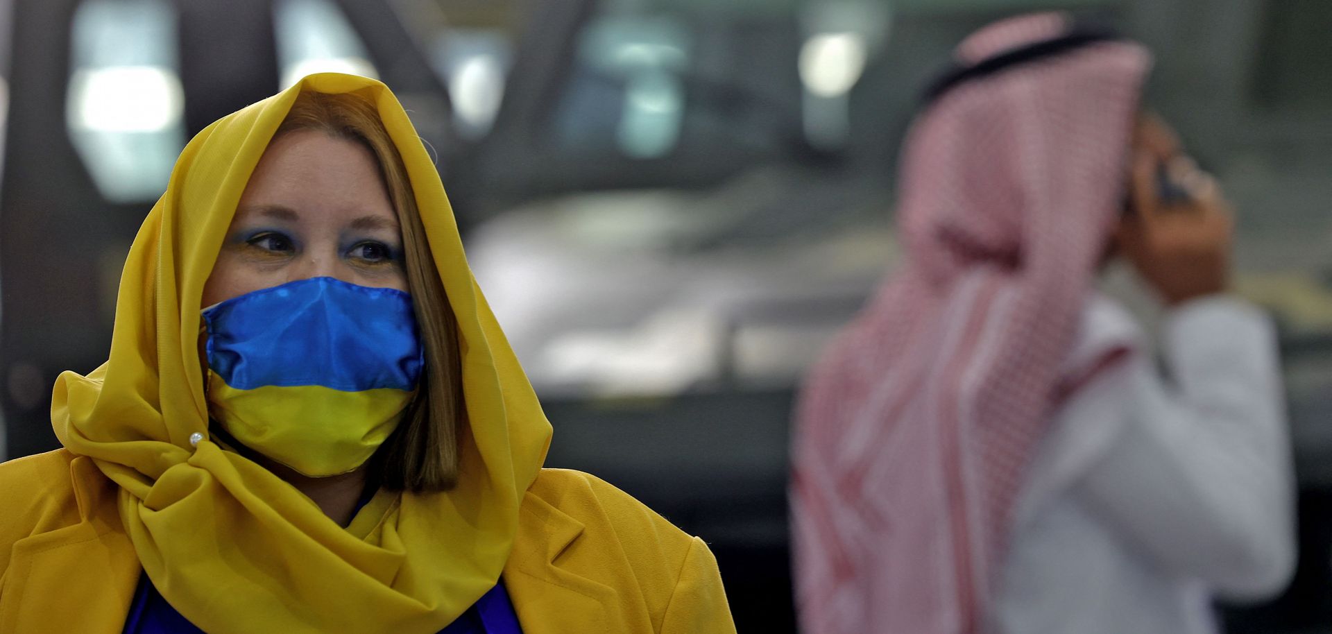 A worker at one of the stands at Saudi Arabia's first World Defense Show in Riyadh is seen wearing clothes in support of Ukraine on March 8, 2022.