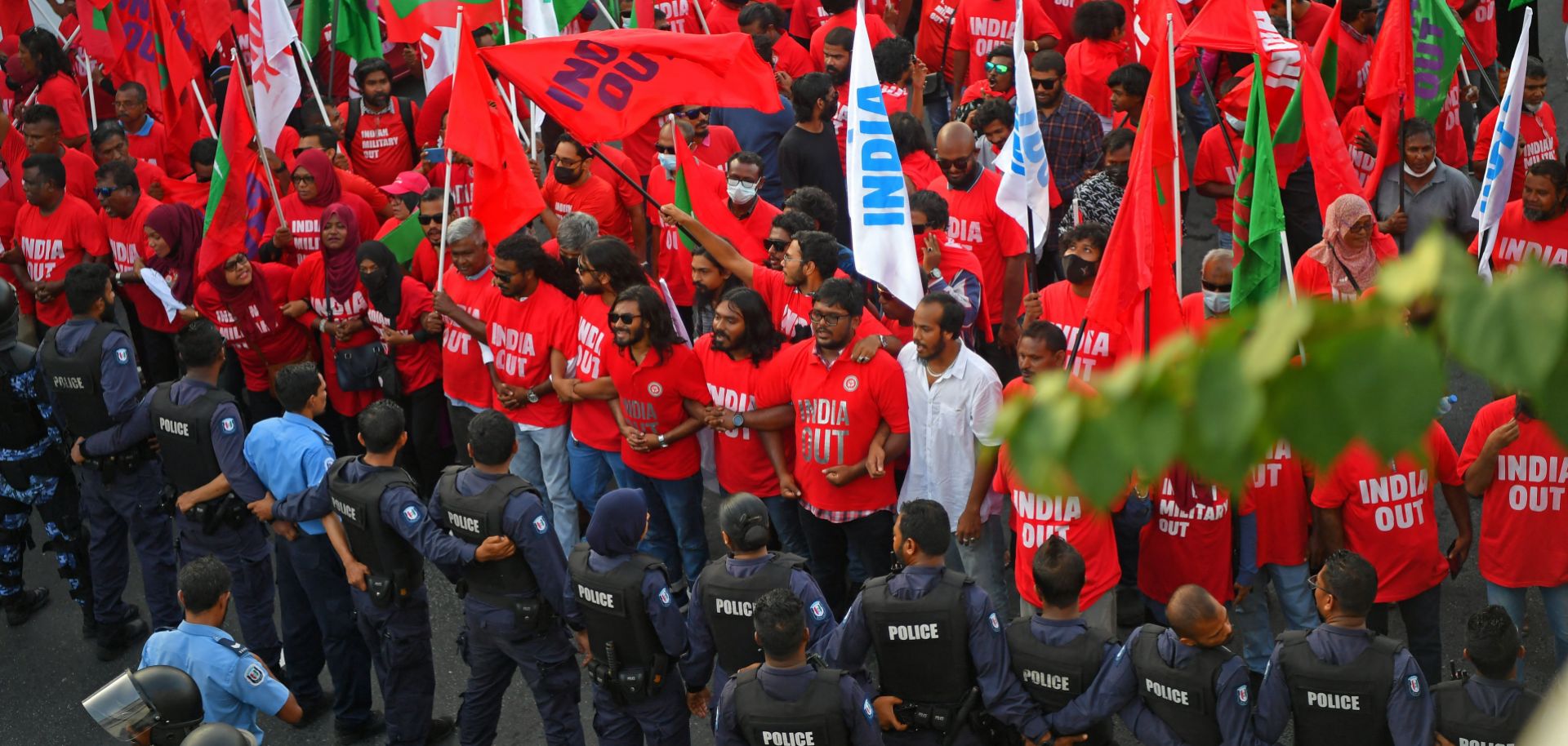 Police stand guard in Male, the Maldives, as protesters take part in an anti-India rally organized by the island nation's opposition coalition on March 25, 2022. 