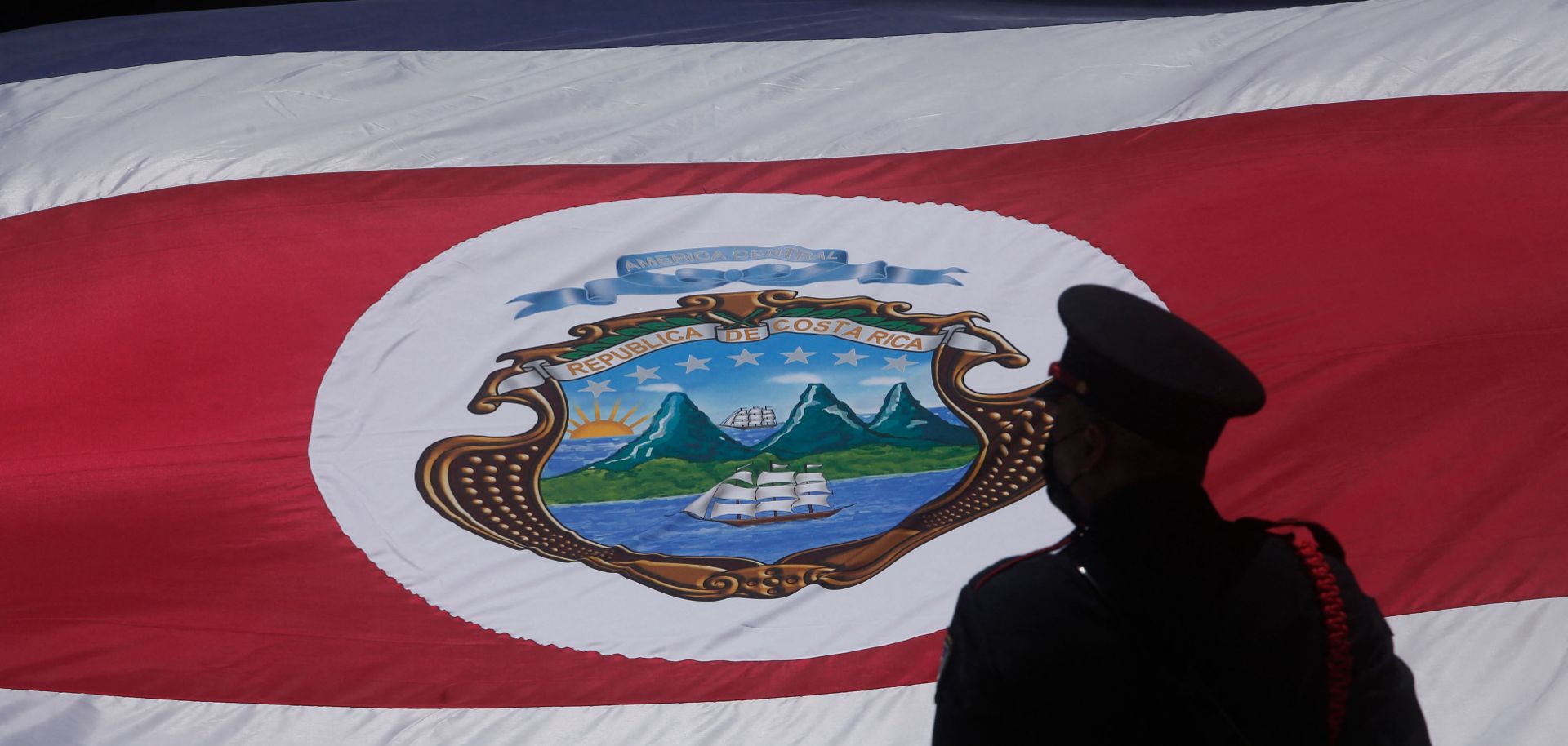 A guard stands next to a Costa Rican flag during the inauguration ceremony of the country’s new president Rodrigo Chaves in San Jose on May 8, 2022.