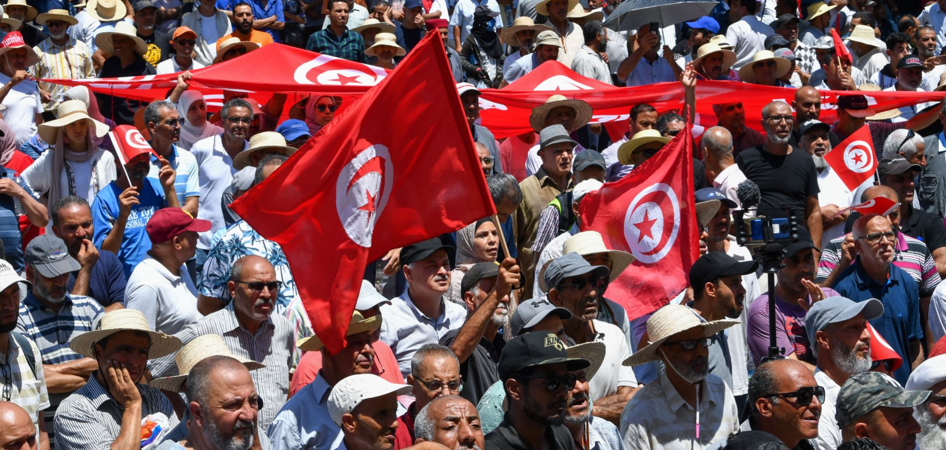 Demonstrators in Tunis, Tunisia, lift national flags during a protest on June 19, 2022, against President Kais Saied and the country’s upcoming constitutional referendum. 