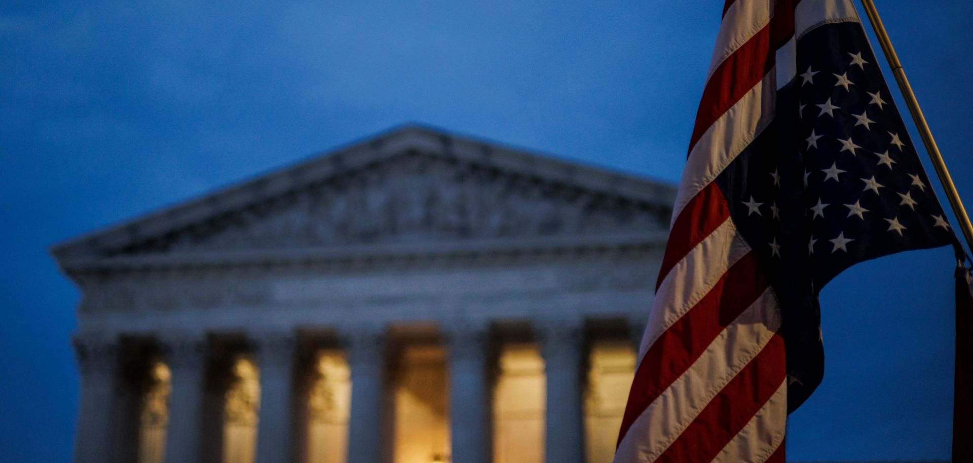 An abortion rights activist flies an upside-down U.S. flag, the international sign of distress, outside of the U.S. Supreme Court during a protest in Washington, D.C., on June 26, 2022, after the landmark Roe v. Wade decision was overturned. 