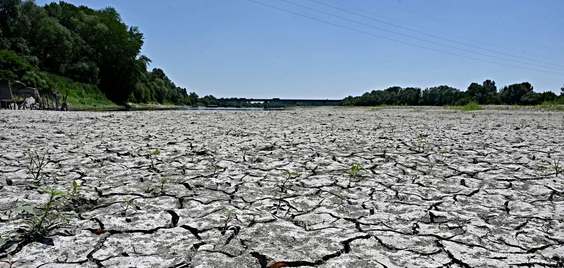 A photo taken on July 5, 2022, shows the dried-up river bed of the Po River in Italy's Veneto region. Water levels in Italy's largest river have reached record lows amid a severe drought.