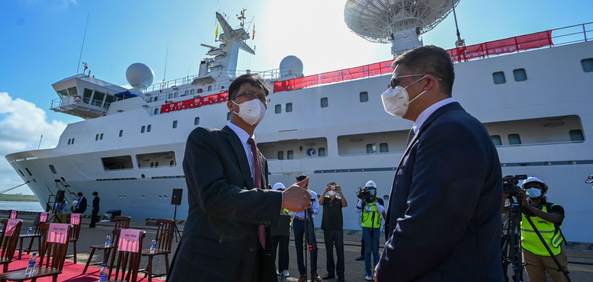 China's ambassador to Sri Lanka (left) gestures upon the arrival of China's research and survey vessel, the Yuan Wang 5, at the Hambantota port on Aug. 16, 2022. 