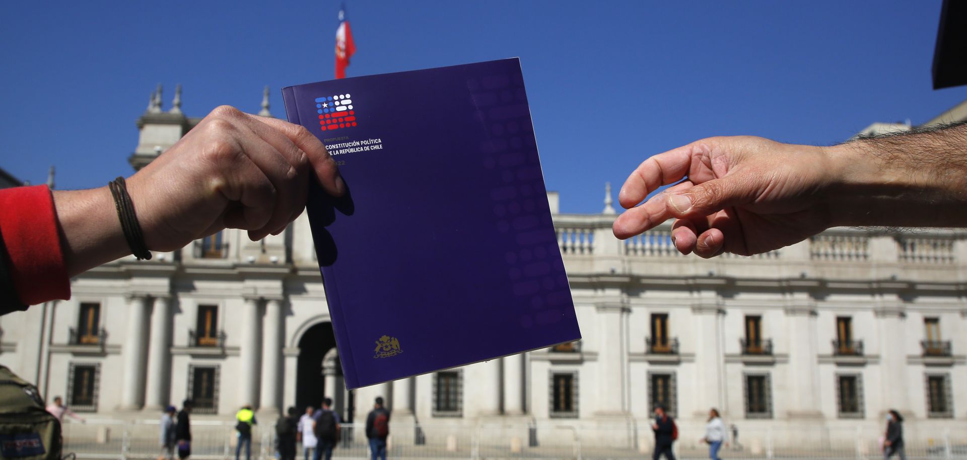 Citizens in Santiago receive a copy of the proposed new Chilean constitution on Aug. 29, 2022, ahead of the upcoming referendum. 