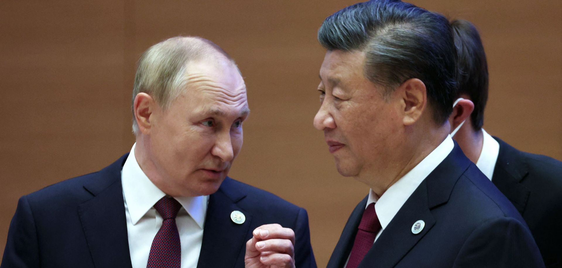 Russian President Vladimir Putin speaks to Chinese President Xi Jinping during the Shanghai Cooperation Organisation (SCO) leaders' summit on Sept. 16, 2022. 
